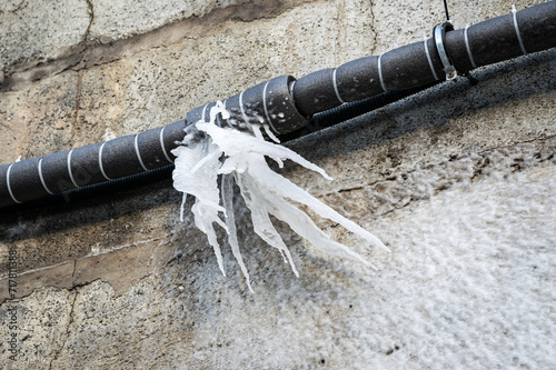 Frozen water after burst from a pipe at the winter.