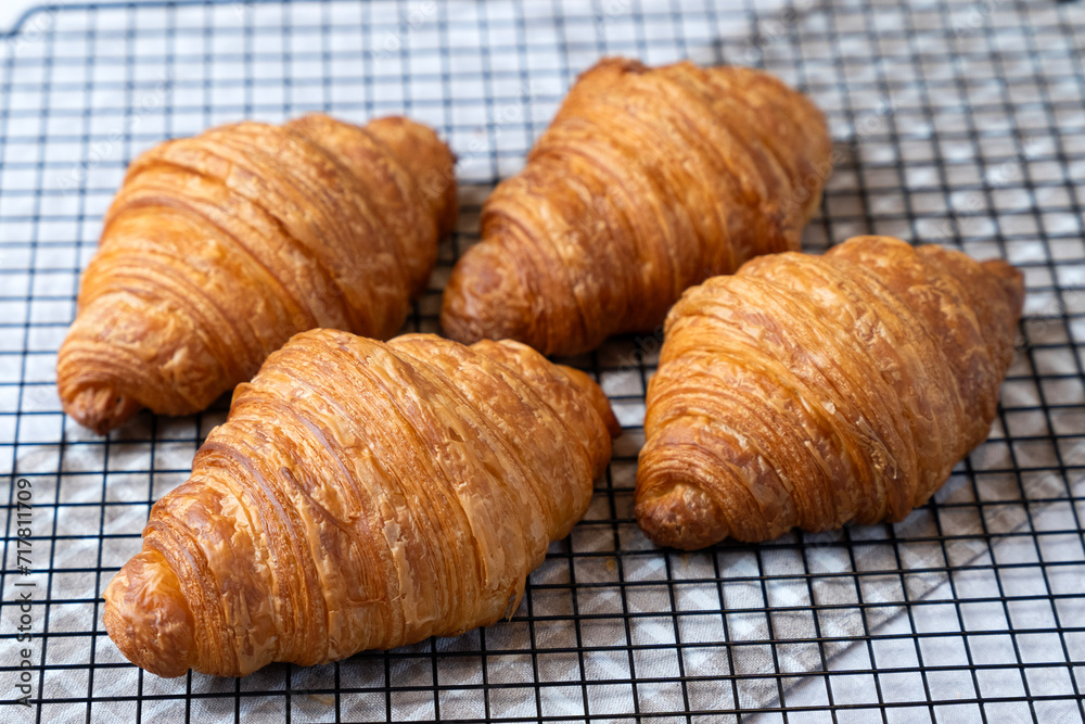 Freshly baked golden French croissants on baking sheet. Fresh classic pastries. Freshly baked golden French croissants on baking sheet. Fresh classic pastries.