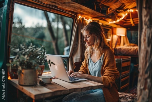 Young woman digital nomad engaging in remote work outside her vintage camper van, epitomizing the mobile, van life lifestyle, Generative AI photo