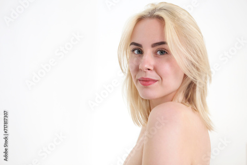 Young beautiful woman with blonde hair on white background