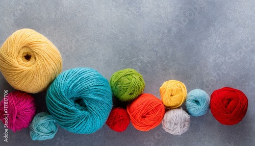Crafting Harmony: Rainbow Wool Yarns on a Stylish Gray Backdrop"