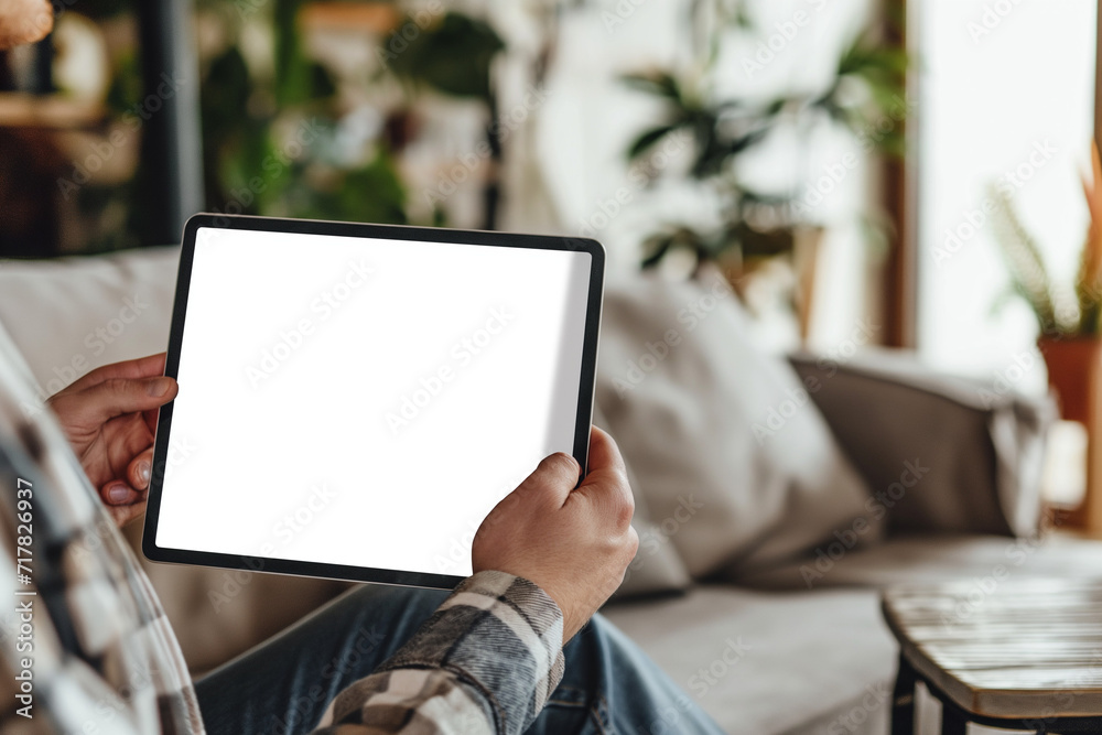 cropped view of man holding digital tablet with blank screen at home cropped view of man holding digital tablet with blank screen at home