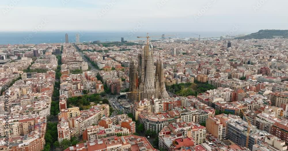 Sagrada Familia aerial view residential area of Barcelona, Spain. Architectural heritage country at sunny day in summer on slide from drone turn. Eixample residential district. Go Everywhere. Travel Sagrada Familia aerial view residential area of Barcelona, Spain. Architectural heritage country at sunny day in summer on slide from drone turn. Eixample residential district. Go Everywhere. Travel