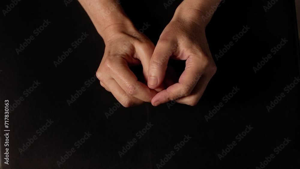 Close-up of male hands touching nails due to stress against black background. Hand movements of a man under tension. Body language.
Close-up of male hands touching nails due to stress against black background. Hand movements of a man under tension. Body language.