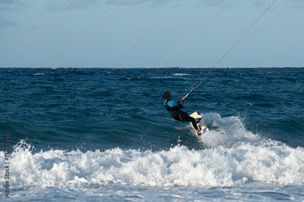 Fototapeta premium Kite surfing.Windsurf.Kite boarding. To fly a kite. Surfers of all ages train in the Mediterranean. Flying a kite on the beaches of Cyprus.