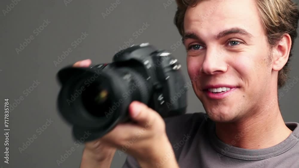 Photographer man, camera and shooting by studio background with smile, click or ideas for magazine job. Journalist, paparazzi persona and happy creative in photoshoot, lens and picture for newspaper