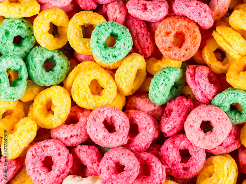 sweet colorful cereal rings on a white plate.