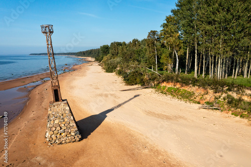 old ruins of Kurmrags Lighthouse on the shore of the Rigas Gulf, Baltic sea, Latvia photo