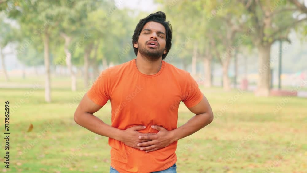 Young Indian Man Having Indigestion Young Indian Man Having Indigestion