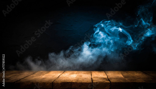 Dark background, an empty wooden table with smoke floats up. Empty space for displaying products