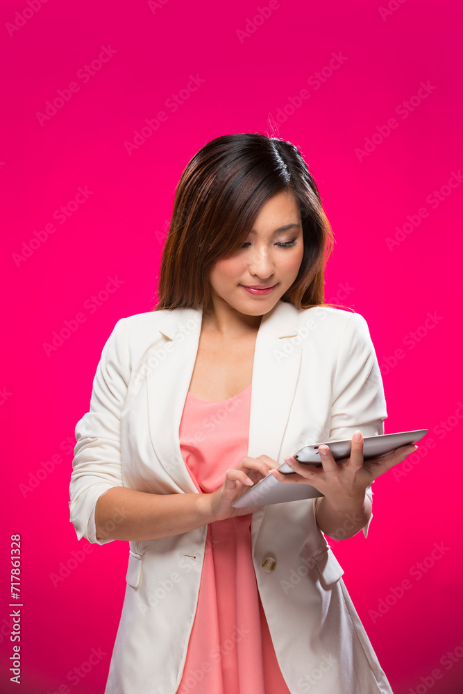 Happy Chinese Woman using a digital tablet. Happy Chinese Woman using a digital tablet.