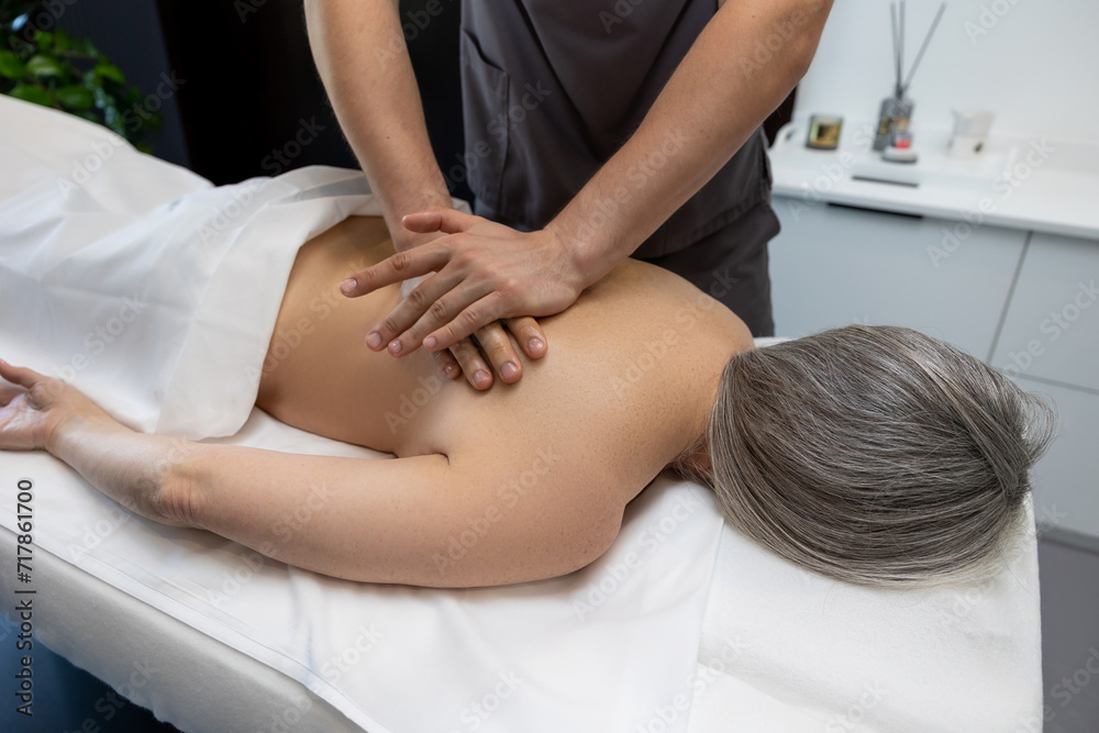 Close up of female patient having back massage in a clinic