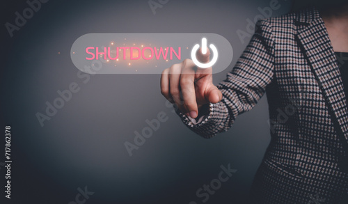 Businesswoman hand pressing the shutdown button on the virtual screen. Digital technology, system shutdown or stops working concept.