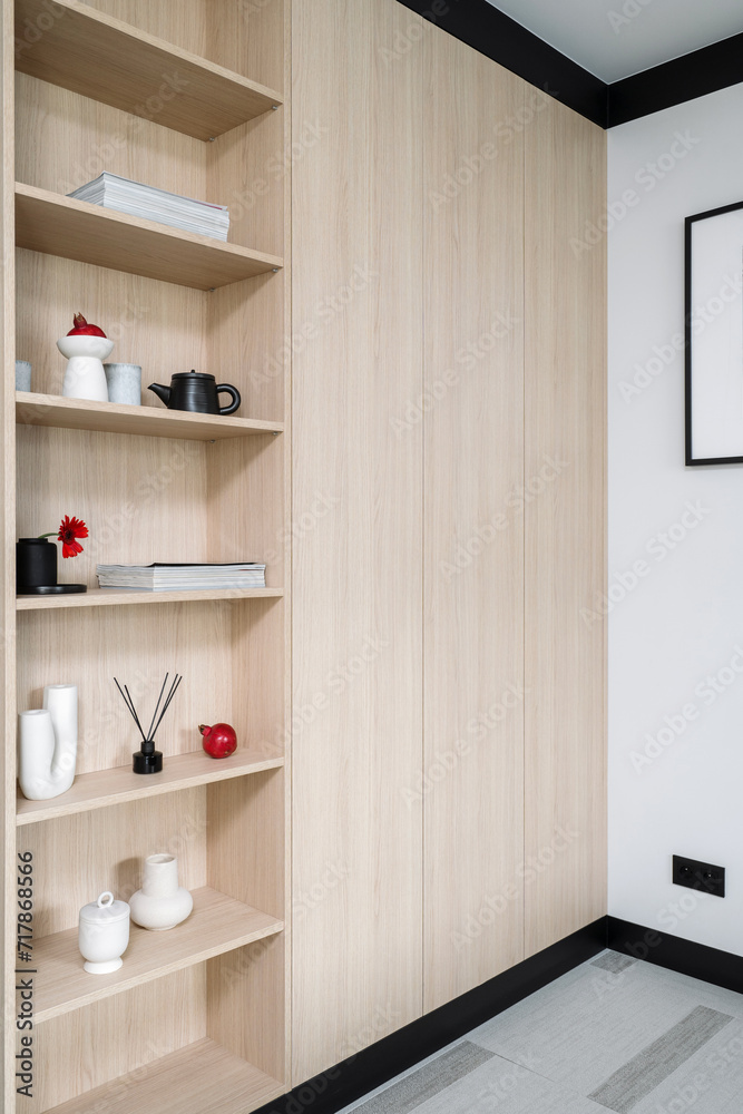 Fototapeta premium Modern wooden closet with shelves at apartment with contemporary interior