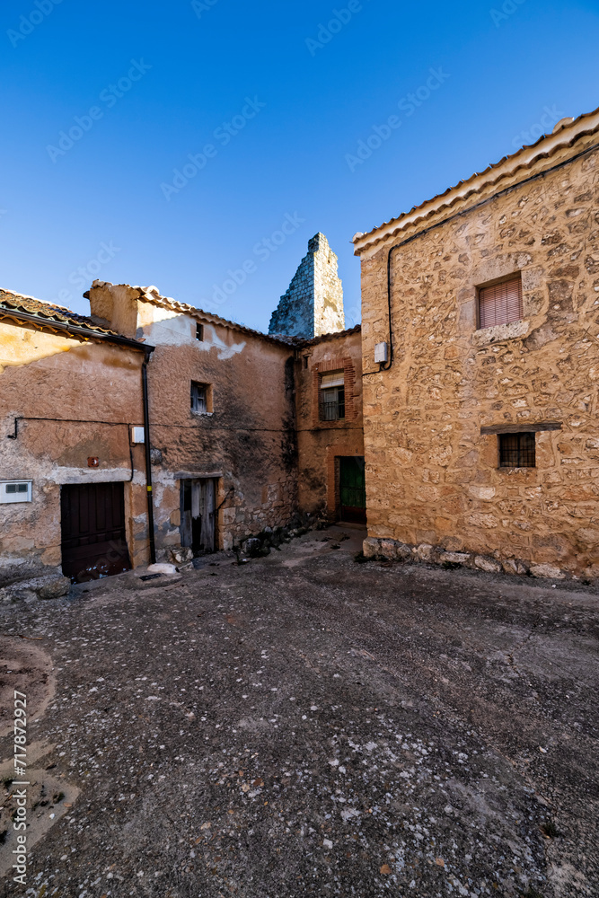 Typical street and ruins of the old tower at the medieval village of Maderuelo. Segovia. Spain. Europe.