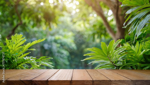 Wooden counter for product placement  outdoor tropical garden. Forest blurred green plant background