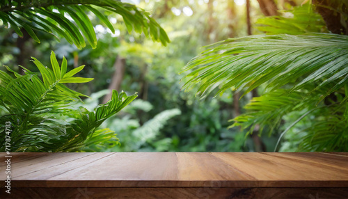 Empty table top  wooden counter for product placement  outdoor tropical garden. Forest blurred green plant background