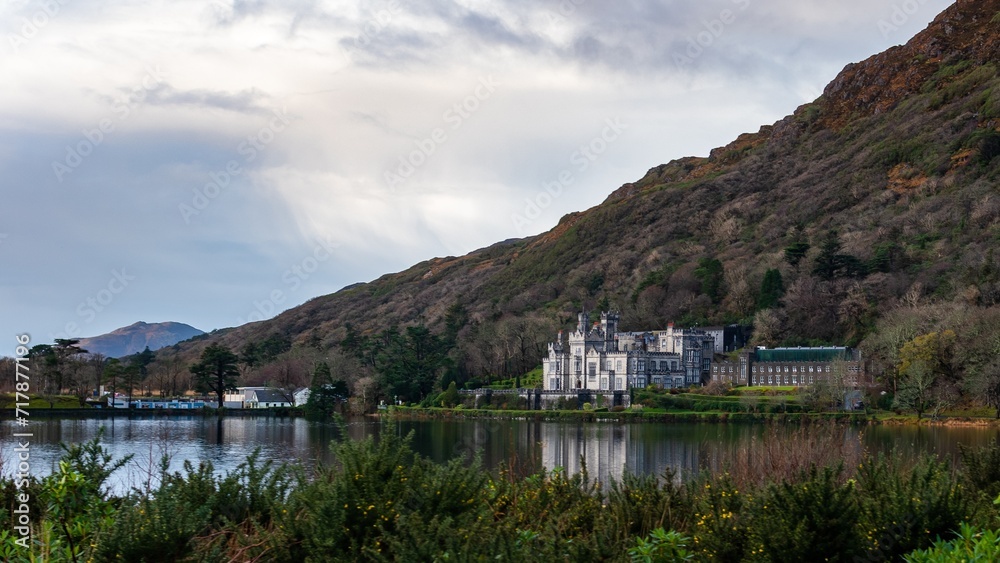 View of Kylemore Abbey on a wintry day being reflected by the waters of Pollacapall Lake.