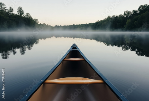 Bow of a canoe in the morning on a misty lake