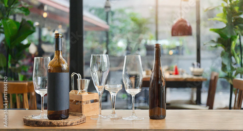 wine glasses on a table, Bottles and glasses on table, cafe background with blank space.