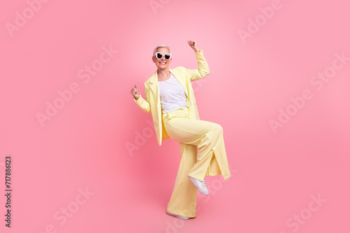 Full length photo of successful businesswoman in sunglasses raised fists up finally going to vacation isolated on pink color background