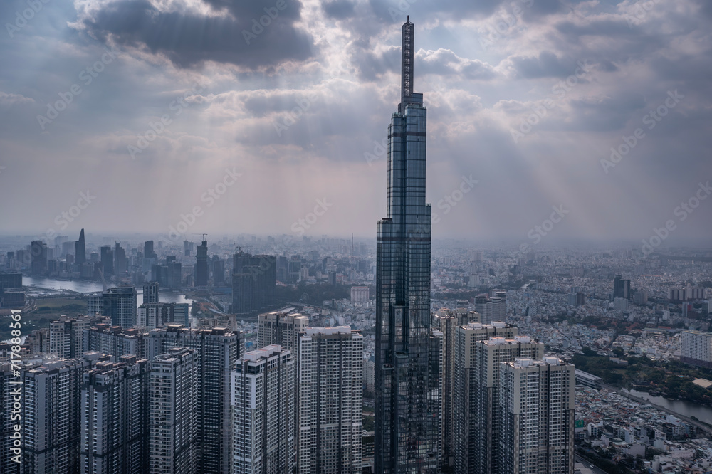 Naklejka premium Saigon river, city skyline, high rise buildings aerial photo with dramatic sky. Landmark building is in the center.