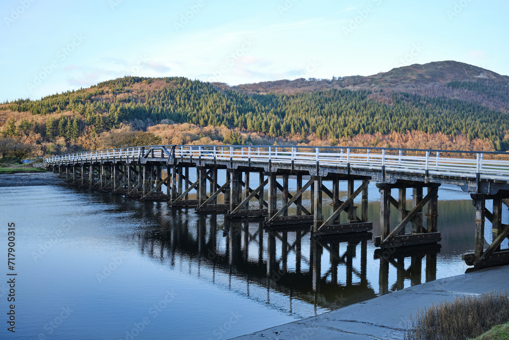Old timber trestle bridge over the River Mawddach in North Wales, UK