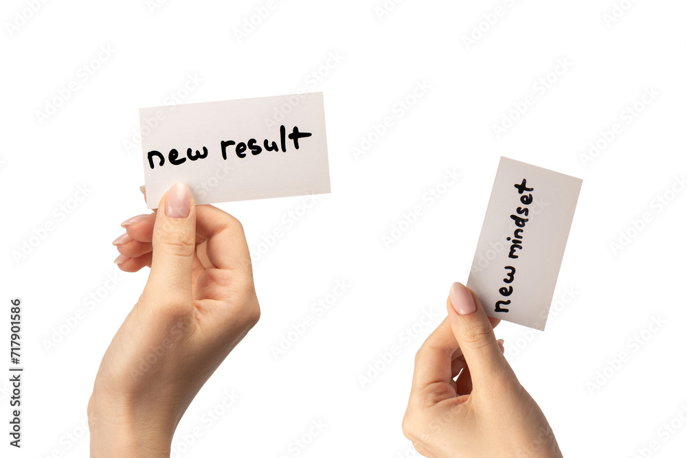 New mindset - new result text on a card in a woman hand. New mindset - new result text on a card in a woman hand.