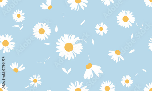 Seamless pattern with hand drawn daisy flower and flying petals on blue background vector illustration.