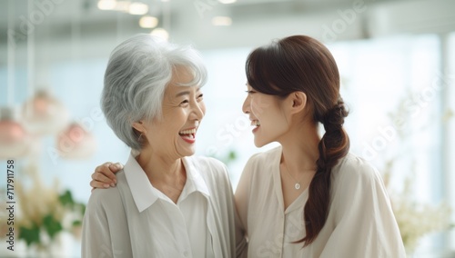A woman smiling and hugging her grandmother
