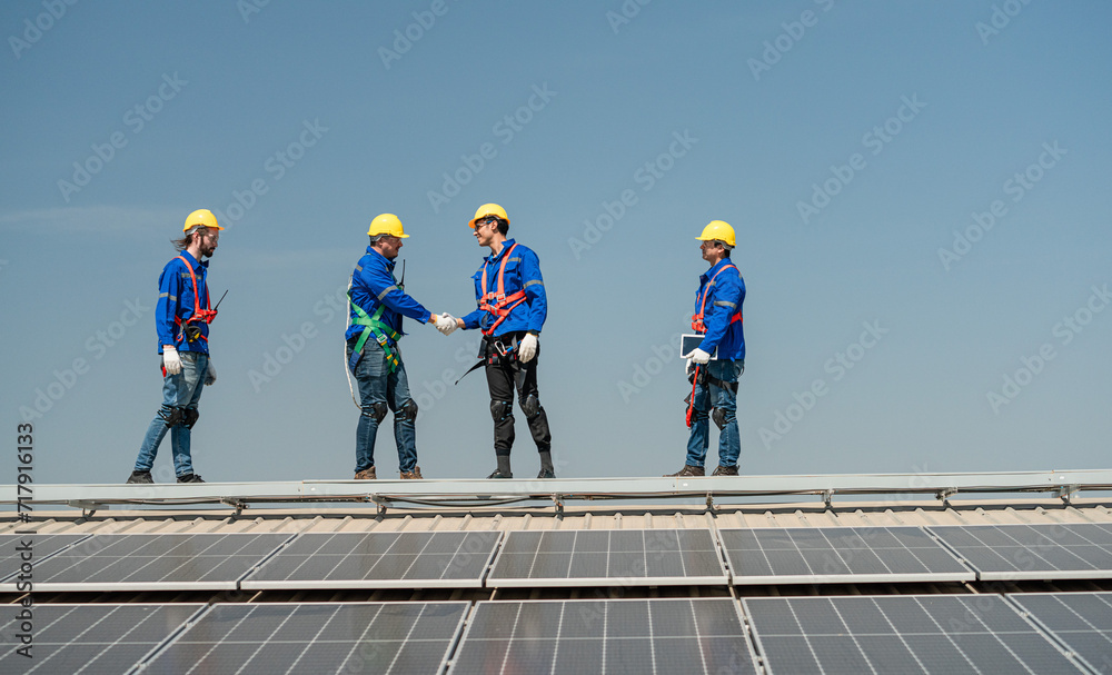 Team of technicians working on the roof eco solar farm Renewable clean energy technology concept Expert engineers teamwork concept