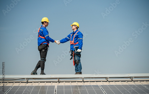 Team of technicians working on the roof eco solar farm Renewable clean energy technology concept Expert engineers teamwork concept