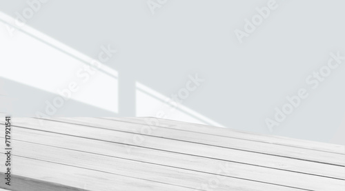empty table with window shadow on light wall background for product mockup display. kitchen interior theme