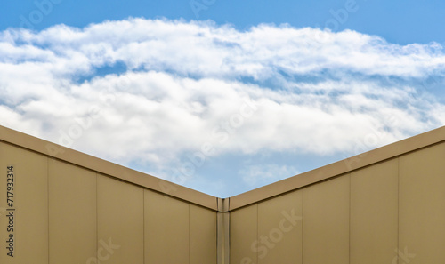 corner of a modern building and blue sky with clouds