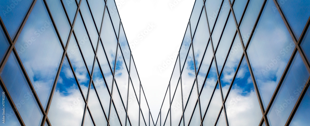 reflection of blue sky with clouds in an office building window - obrazy, fototapety, plakaty 