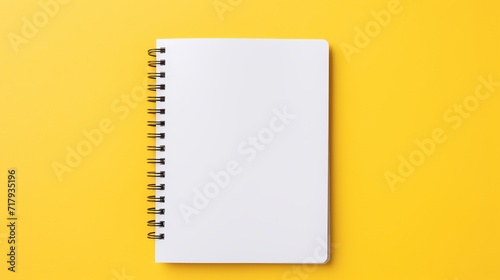 Vibrant yellow background with open notebook - copy space for text, minimalistic office or school concept