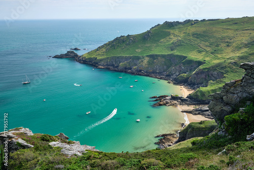 View towards Bolt Head across boats in Starehole Bay near Salcombe seen from the South West Coast Path, Devon, UK