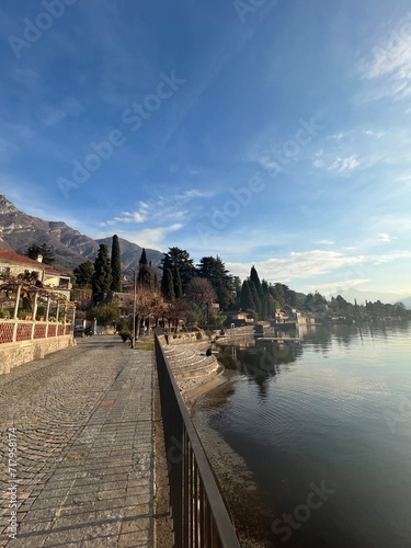View of walk sideway Lake Como Blue water landscape, Lierna in Northern Italy - Calm and relax scene serene with clear sky 