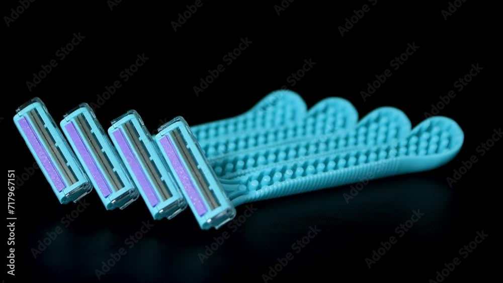 The blue razor shaving on black background. Disposable women's razors The blue razor shaving on black background. Disposable women's razors