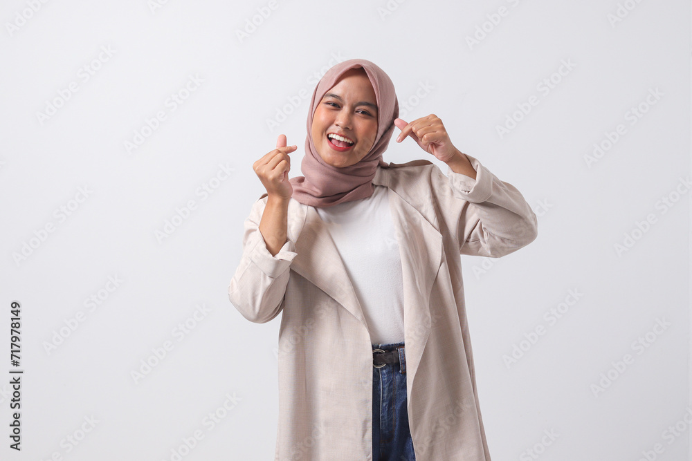 Portrait of excited Asian hijab woman in casual suit making korean ...