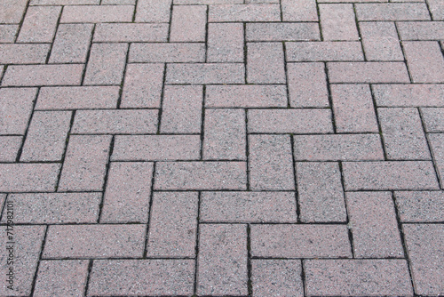Texture of square cobblestone. Pattern of sidewalk tiles in the street. Cobblestones close up.