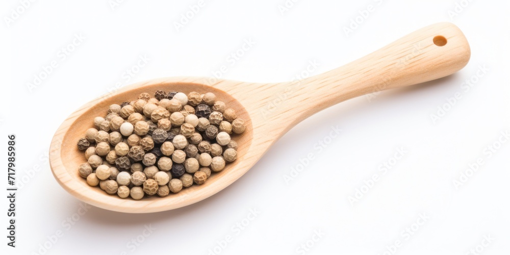 White Pepper Heap In Wooden Spoon On White Background. Top View Of Dry Peppercorn Pile. Organic Seasoning, Spice Condiment White Pepper Heap In Wooden Spoon On White Background. Top View Of Dry Peppercorn Pile. Organic Seasoning, Spice Condiment