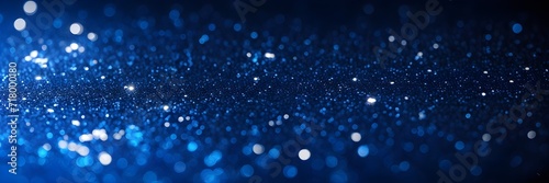 Blue glitter background banner. Abstract blue backdrop with shiny particles and bokeh lights.