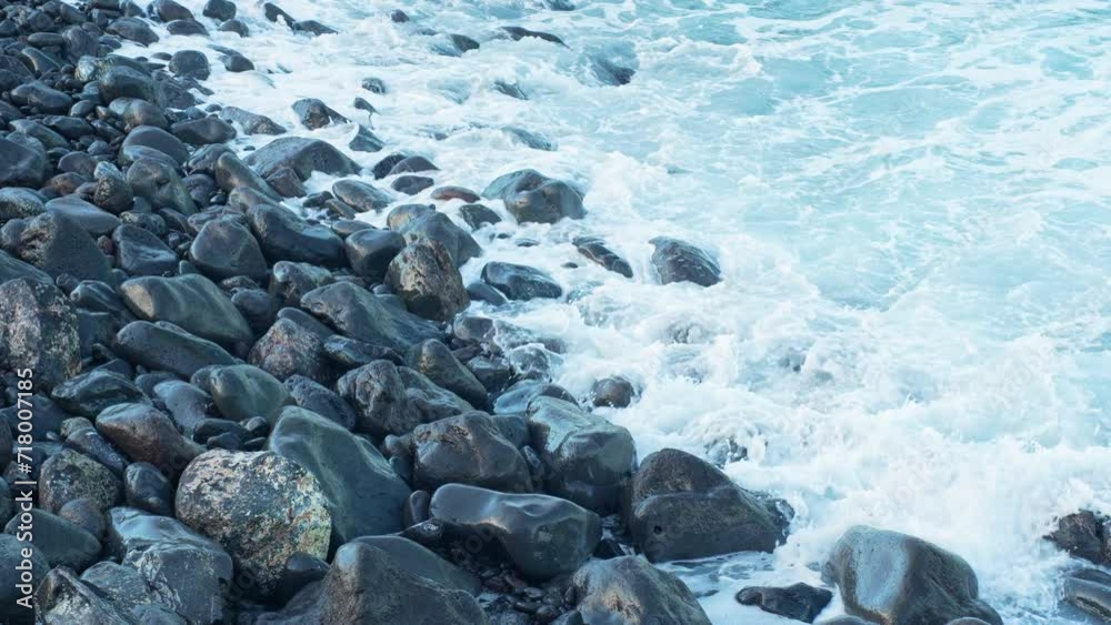 Coastal rocks looks like polished, ocean waves flow over, slow motion Coastal rocks looks like polished, ocean waves flow over, slow motion