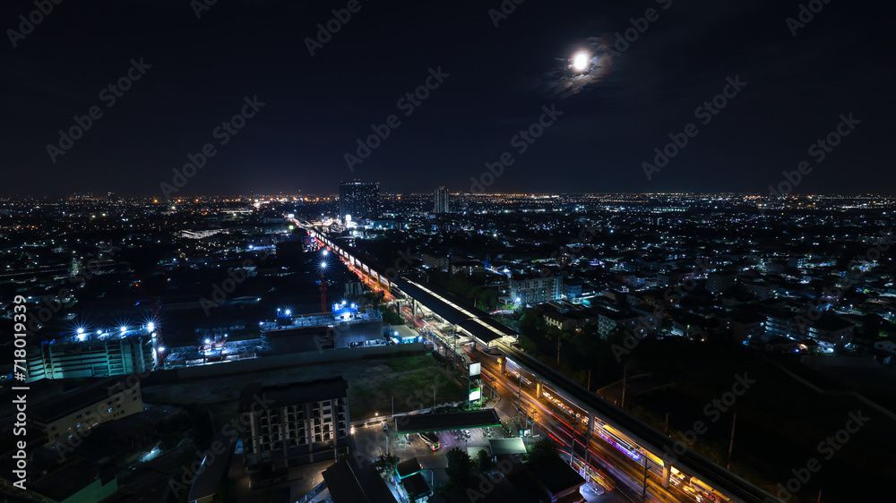 long exposure shot cityscape and electric train station at nighttime, at Samut Prakan province Thailand,