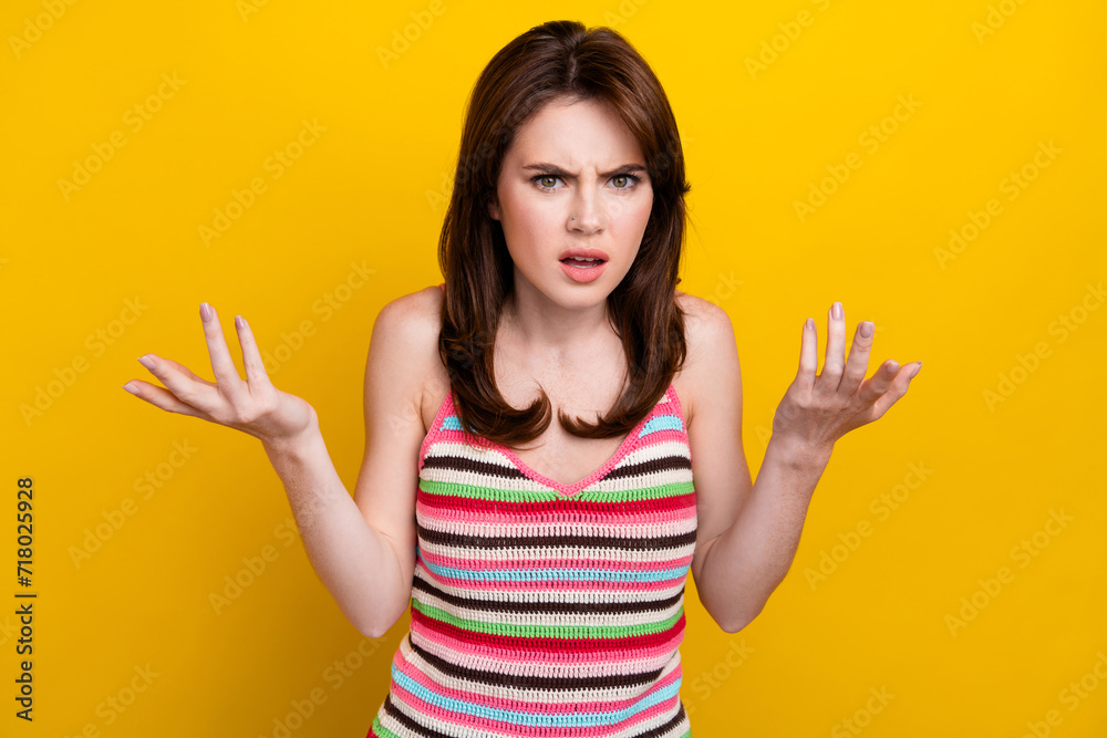 Portrait of dissatisfied offended woman with nose piercing dressed knitwear top raising palms up argue isolated on yellow color background Portrait of dissatisfied offended woman with nose piercing dressed knitwear top raising palms up argue isolated on yellow color background