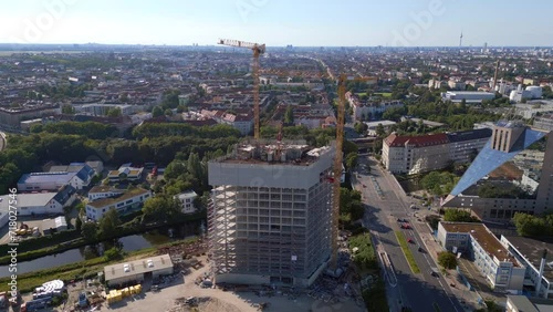 skyscraper under construction Berlin. Amazing aerial top view flight tilt up drone
4k cinematic footage photo