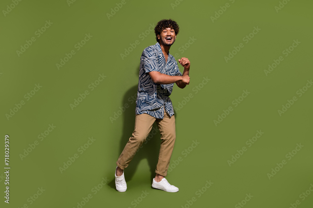 Full body size photo of american best dancer at party doing dynamic moves likes his casual apparel isolated on khaki color background Full body size photo of american best dancer at party doing dynamic moves likes his casual apparel isolated on khaki color background