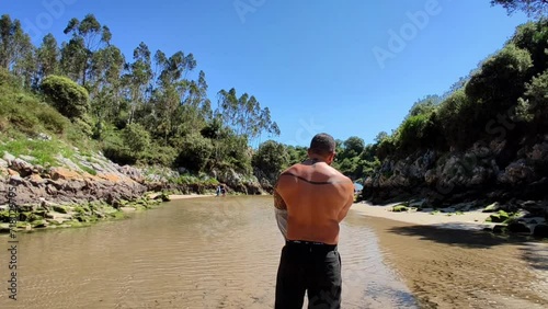 man taking off his shirt in guadamia photo