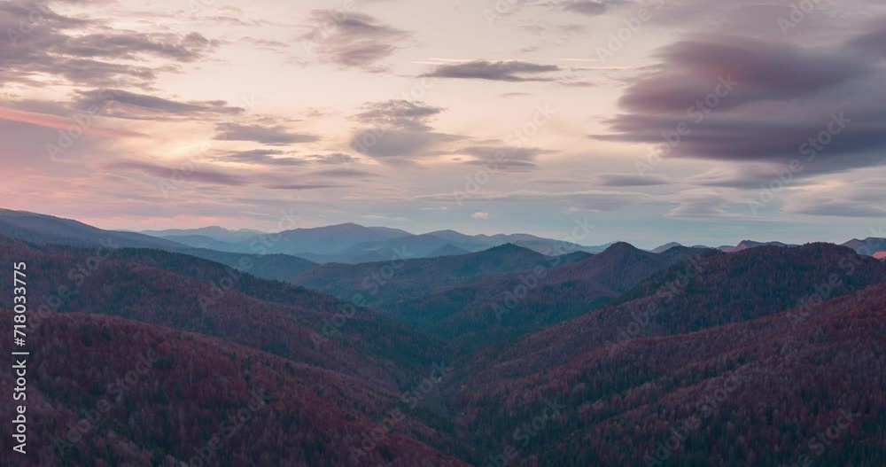 Sunset timelapse on mountain range in Navarra Pyrenees over Irati forest and mountains orange sunset glow and soft light. Snowy mountain peaks, orange and green forest in fall autumn season Sunset timelapse on mountain range in Navarra Pyrenees over Irati forest and mountains orange sunset glow and soft light. Snowy mountain peaks, orange and green forest in fall autumn season